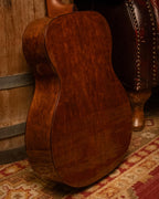 Martin OM-14 Sinker Redwood and Jaguar Claw Mahogany acoustic guitar, showing the body and wood grain details.