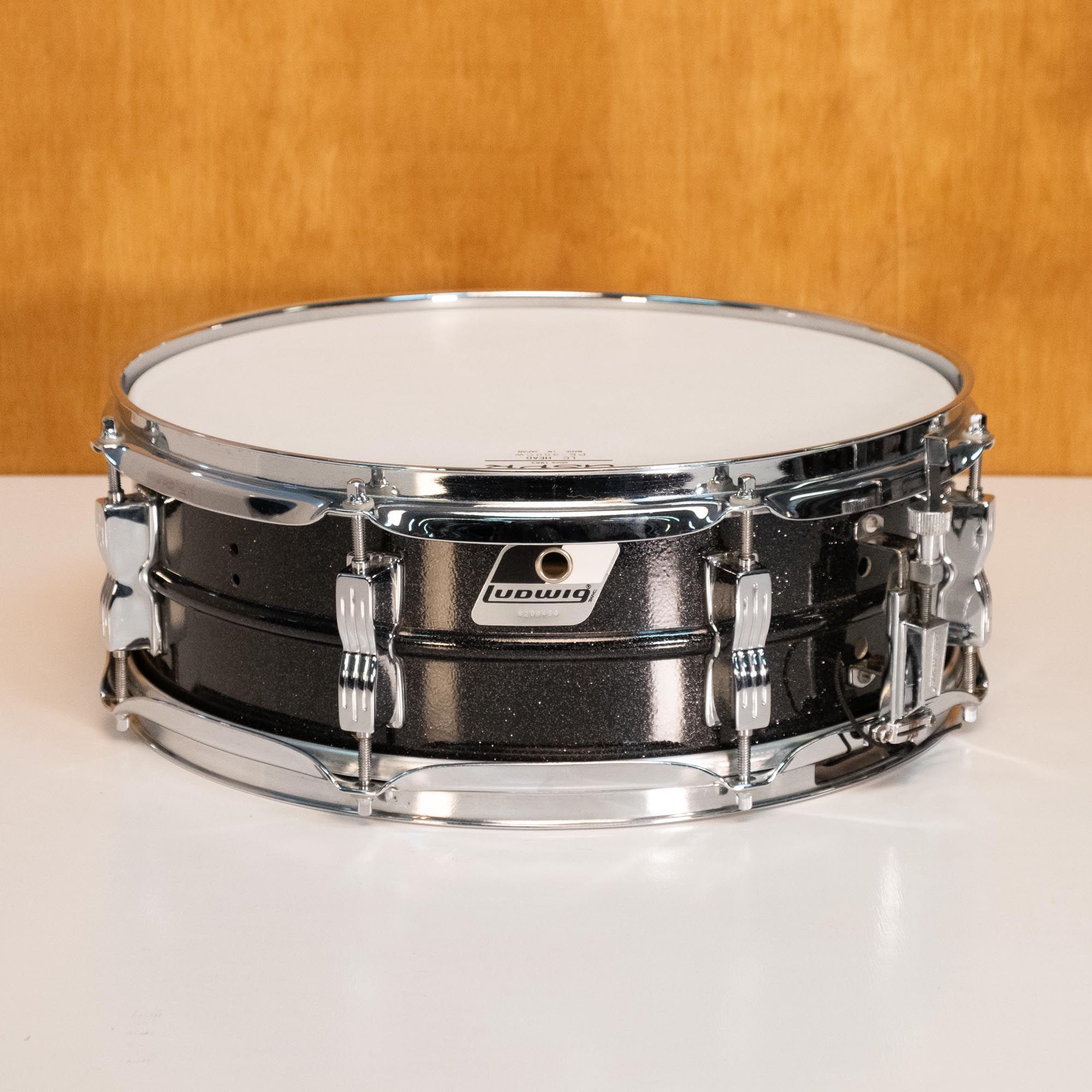 Ludwig Acrolite 14x5 inch snare drum in Black Galaxy finish, showcasing its sleek drum shell and hardware details.