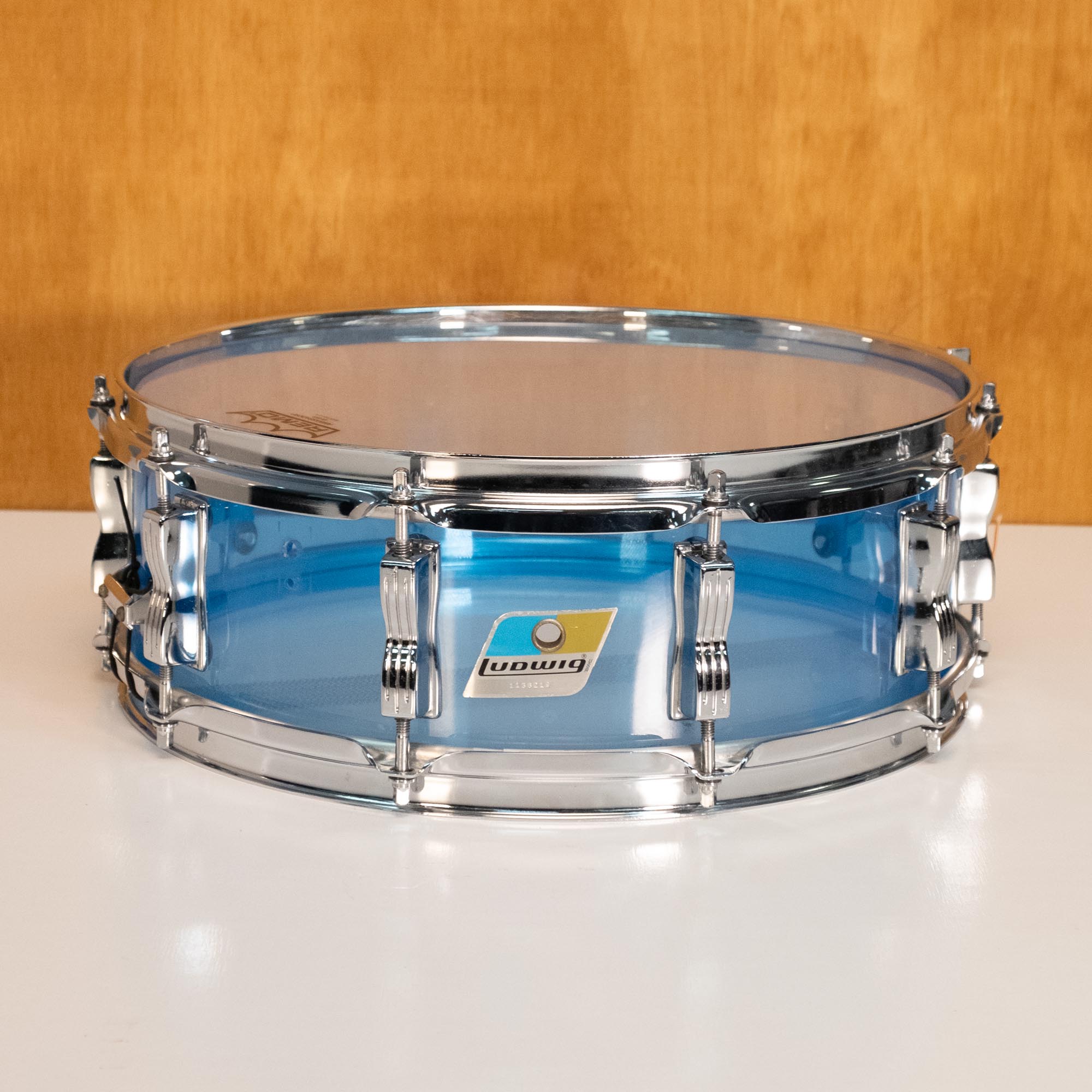 Ludwig '70s Vistalite 14x5 blue snare drum, vintage percussion instrument with clear acrylic shell and metal hardware.