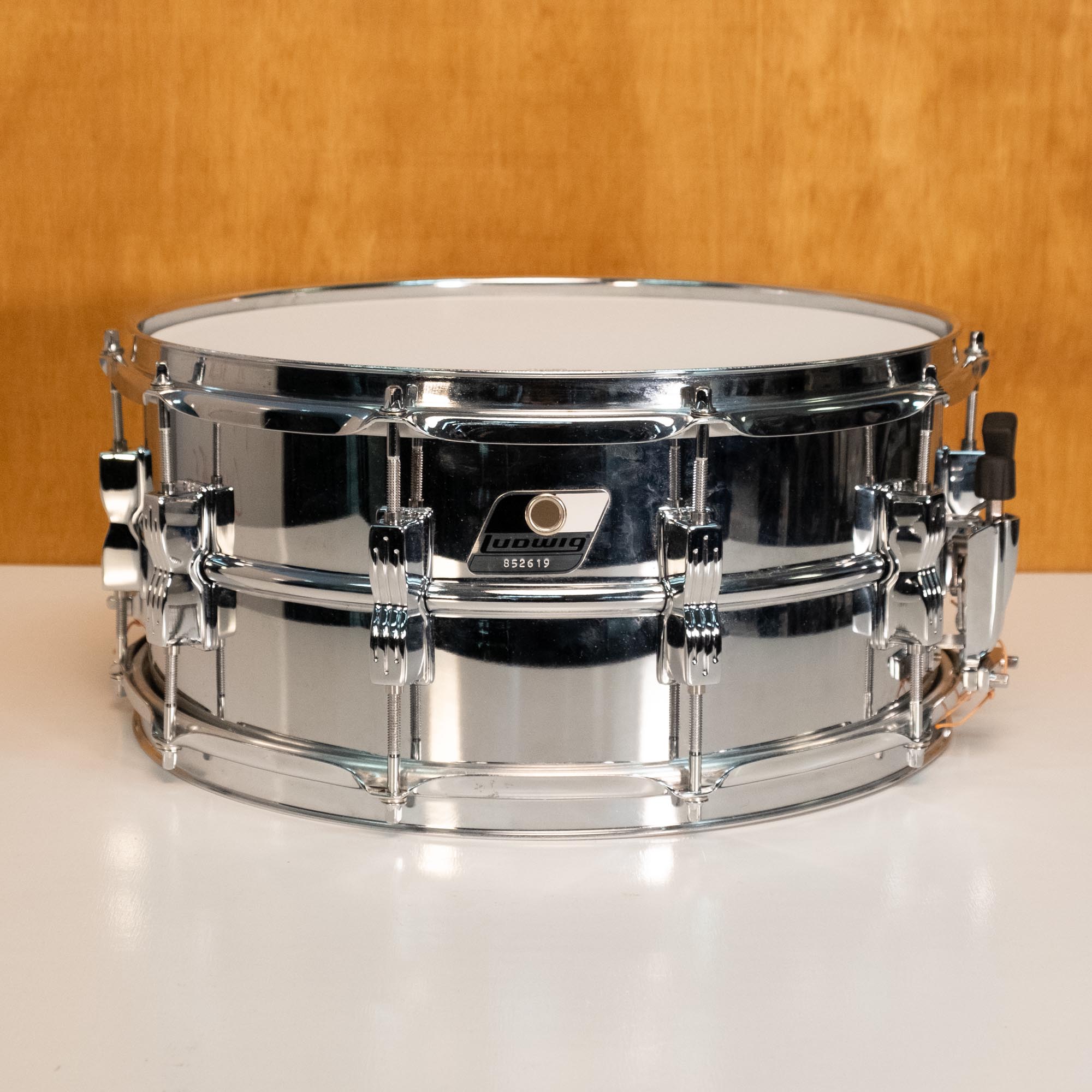 Ludwig LM302 Rocker 14x6.5 chrome steel snare drum, preowned, with shiny chrome finish and detailed hardware visible.