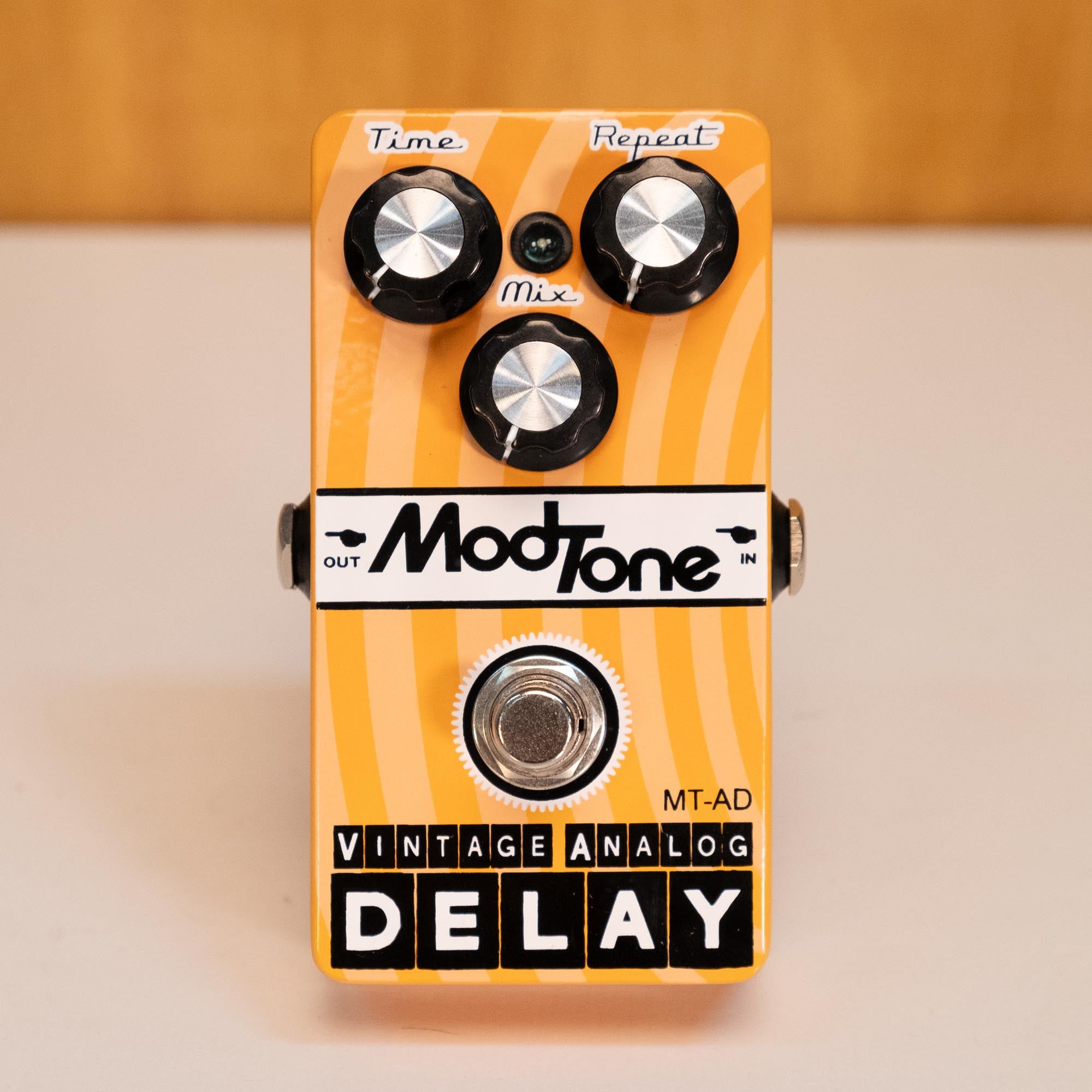 ModTone MT-AD vintage analog delay guitar effects pedal, showing knobs and input jacks on a clean surface.