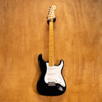 Fender Japan '57 Stratocaster electric guitar in black, showcasing its classic body shape, maple neck, and three single-coil pickups.