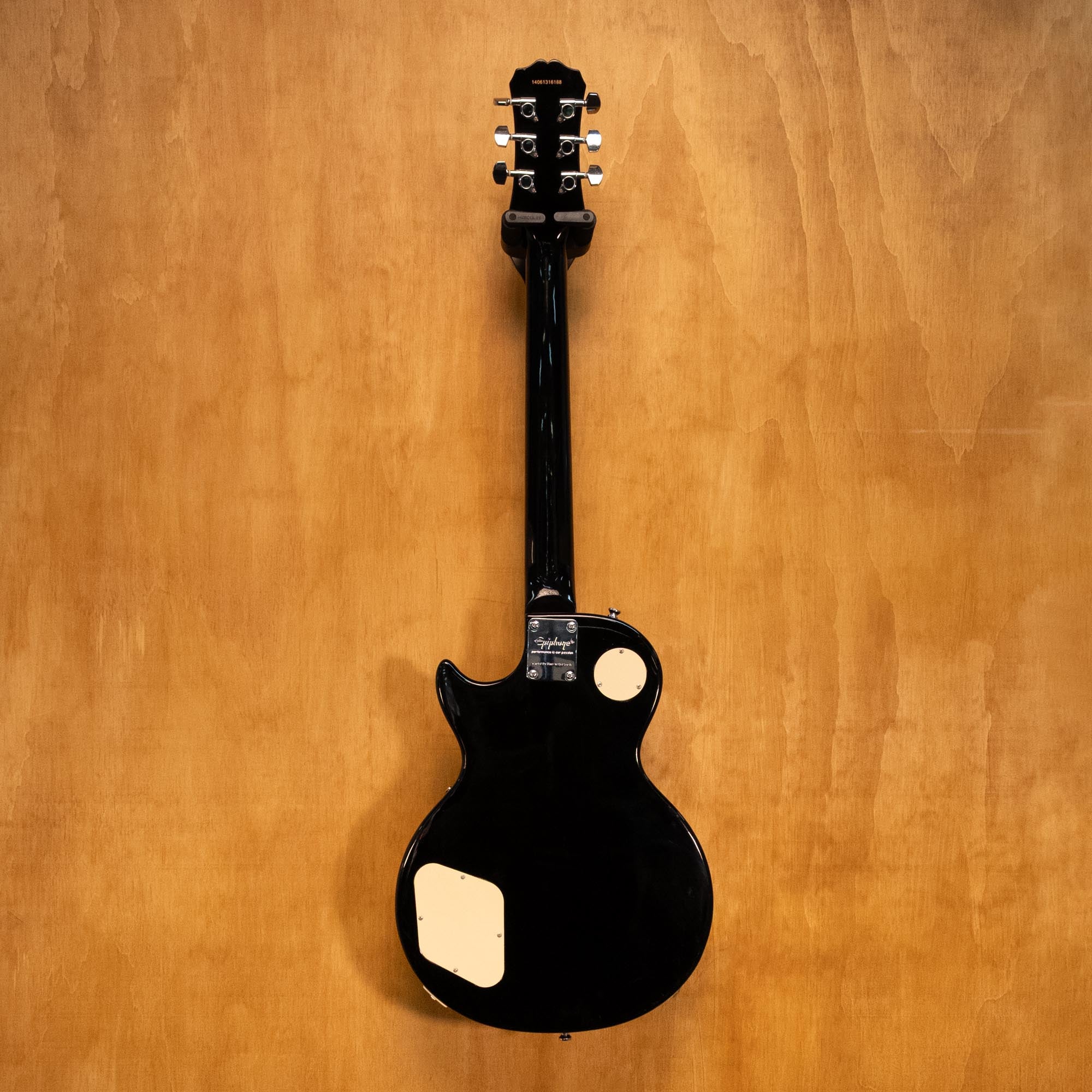 Epiphone Les Paul 100 electric guitar in vintage sunburst finish, shown on a stand with a close-up of the body and pickups.