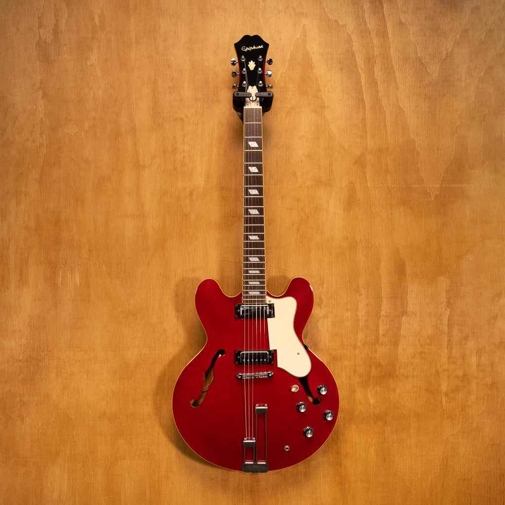 Epiphone Riviera Reissue electric guitar in cherry finish, body and neck detail, shown in a natural studio setting.
