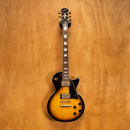 Epiphone Les Paul Custom Plus electric guitar in vintage sunburst finish, shown with body, neck, and pickups in close-up view.