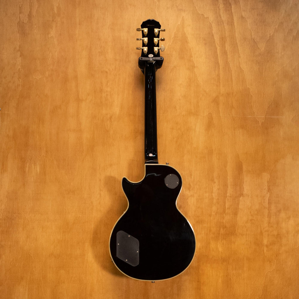Epiphone Les Paul Custom Plus electric guitar in vintage sunburst finish, showing body, pickups, and control knobs.