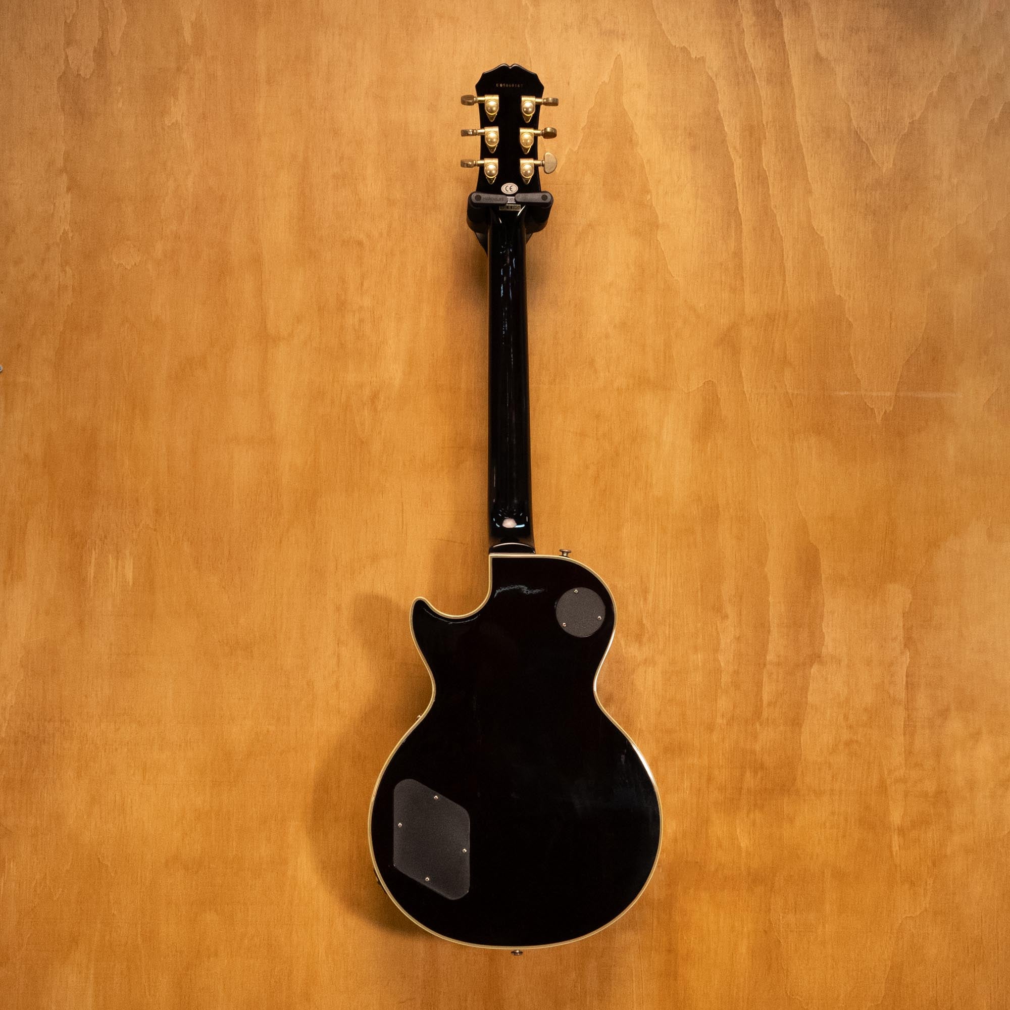Epiphone Les Paul Custom Plus electric guitar in vintage sunburst finish, showing body, pickups, and control knobs.