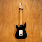 Fender Japan Standard Stratocaster electric guitar in black with white pickguard, six strings, and chrome hardware.
