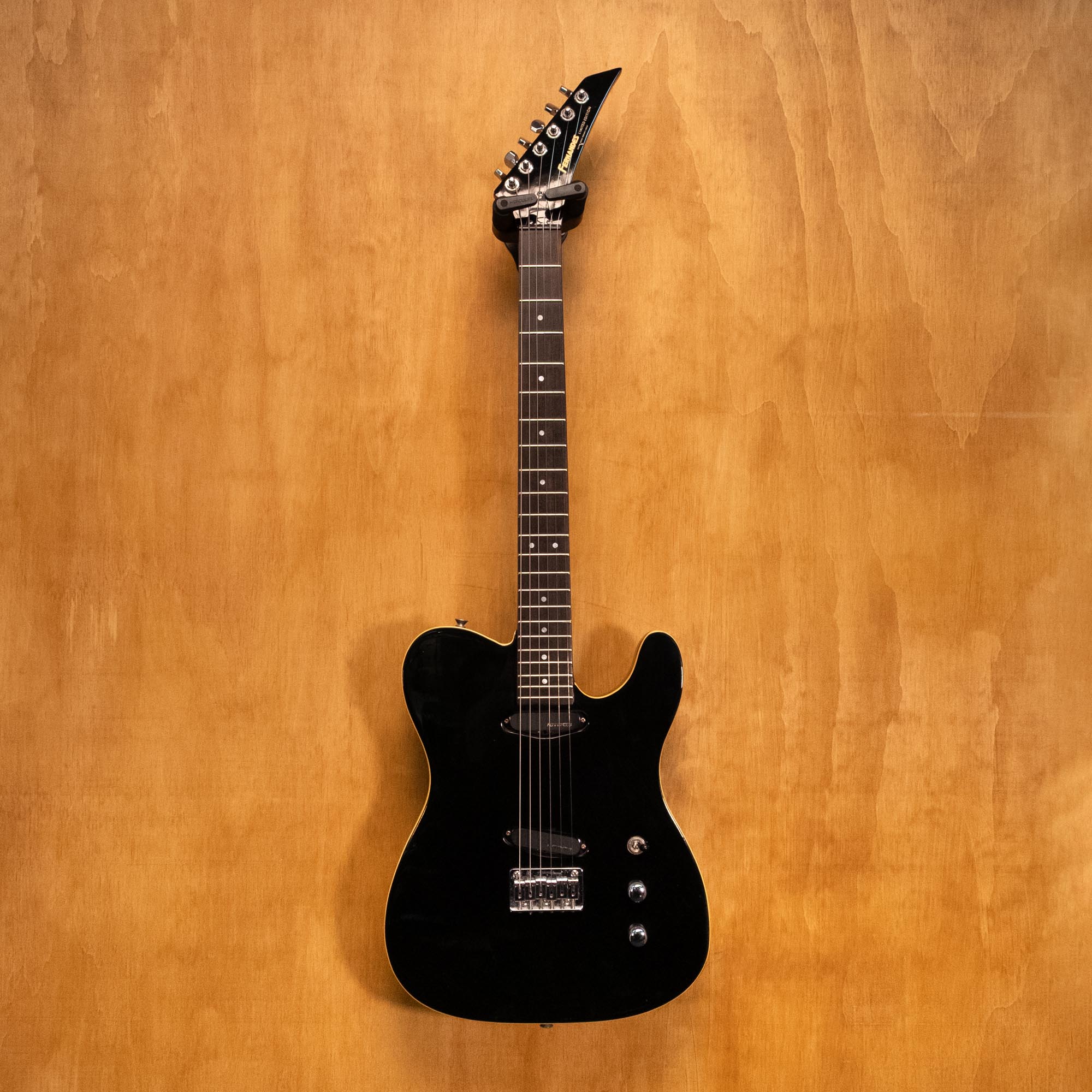 Fernandes T-Syle TEJ-45 electric guitar with sunburst finish, shown on a stand with pickups and control knobs visible.