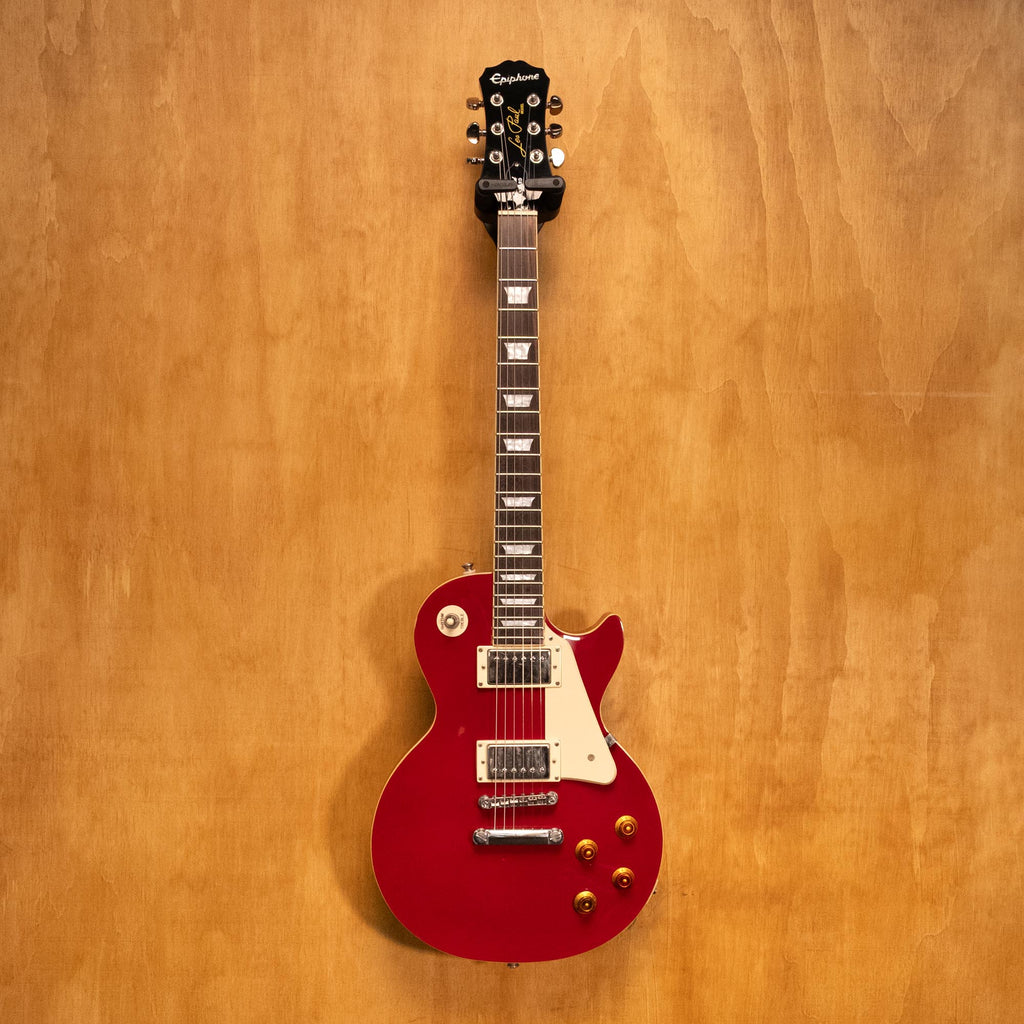 Epiphone Les Paul Standard electric guitar in Cardinal Red with dual humbucker pickups and maple top, close-up view.