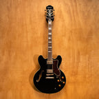 Epiphone Sheraton II electric guitar in ebony finish, showcasing its body, pickguard, and dual humbucker pickups.