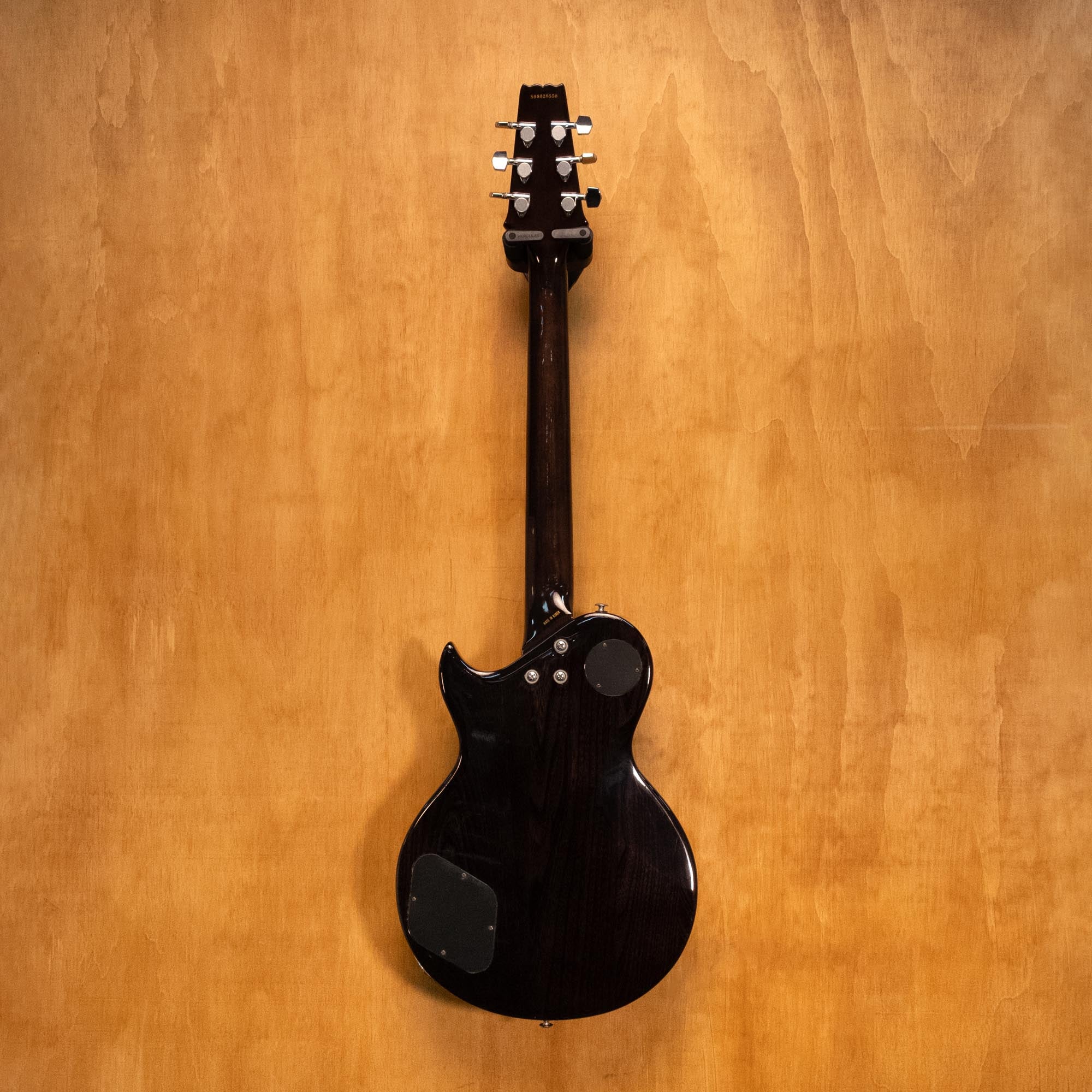 Aria Pro II PE-40 electric guitar in blue burst finish with maple neck and dual humbucker pickups, close-up of the body and strings.