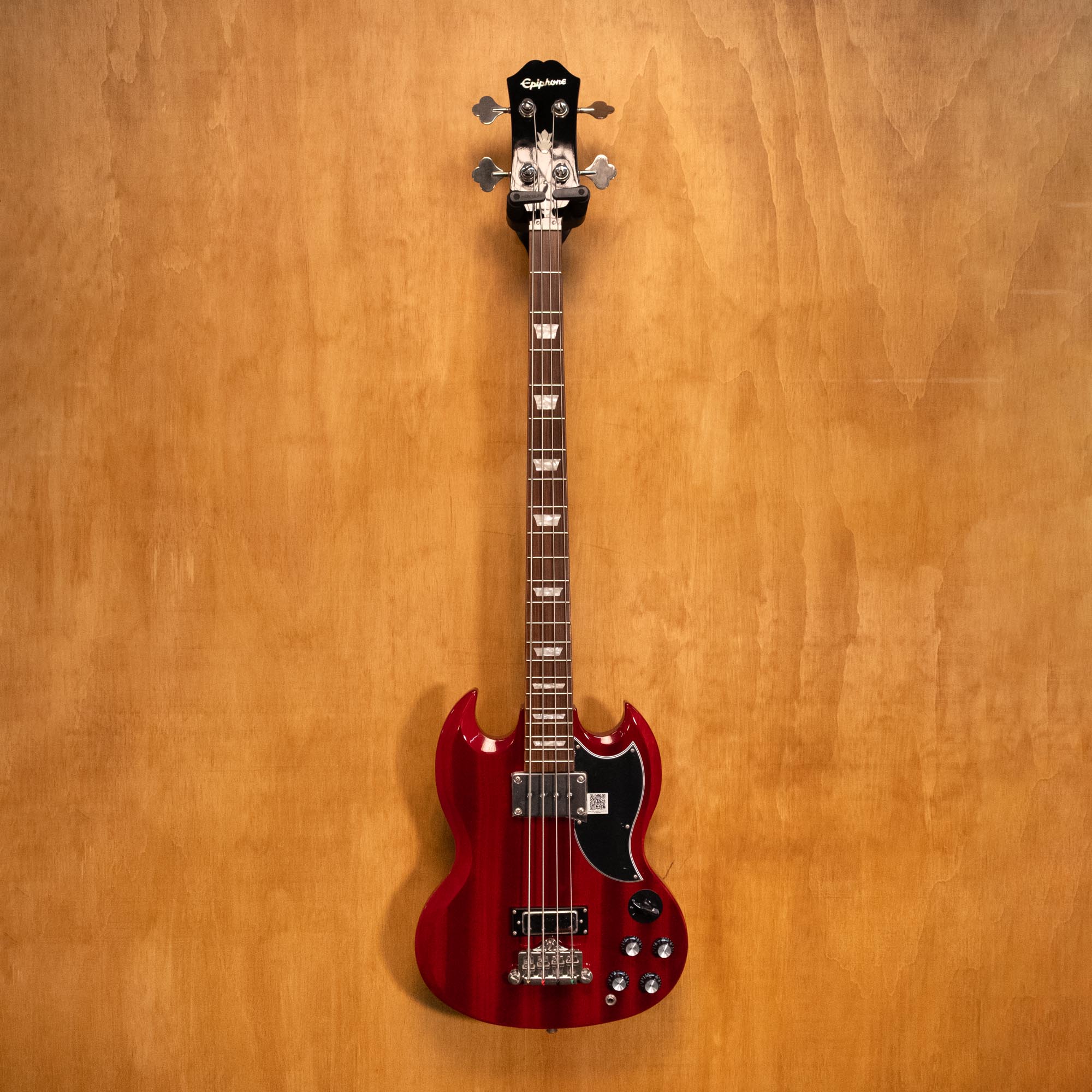 Epiphone SG Bass Guitar EB-3 in cherry finish with two pickups, shown from a front angle, highlighting its classic design and wood grain.