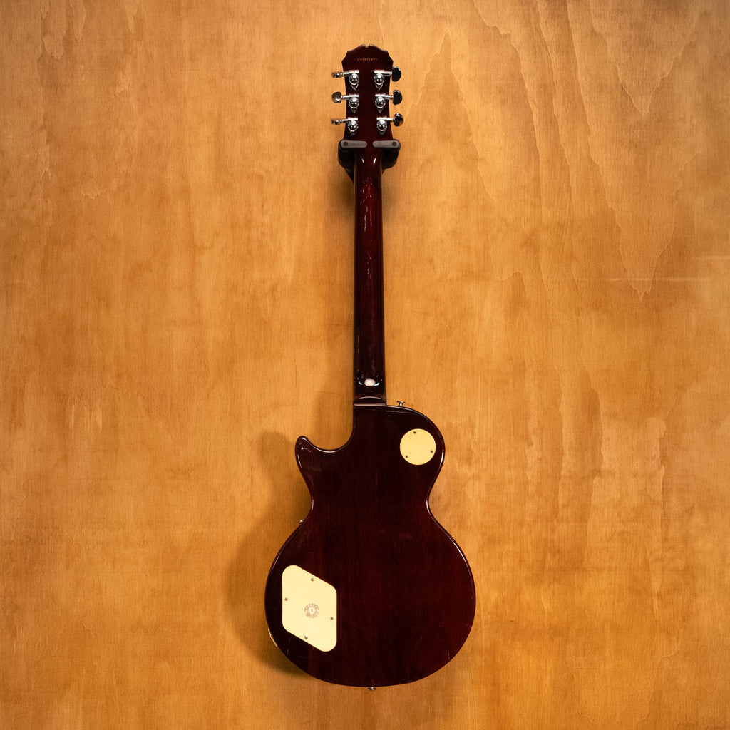 Epiphone 1956 Les Paul Standard Gold Top electric guitar with gold finish and classic design, shown resting on a stand.