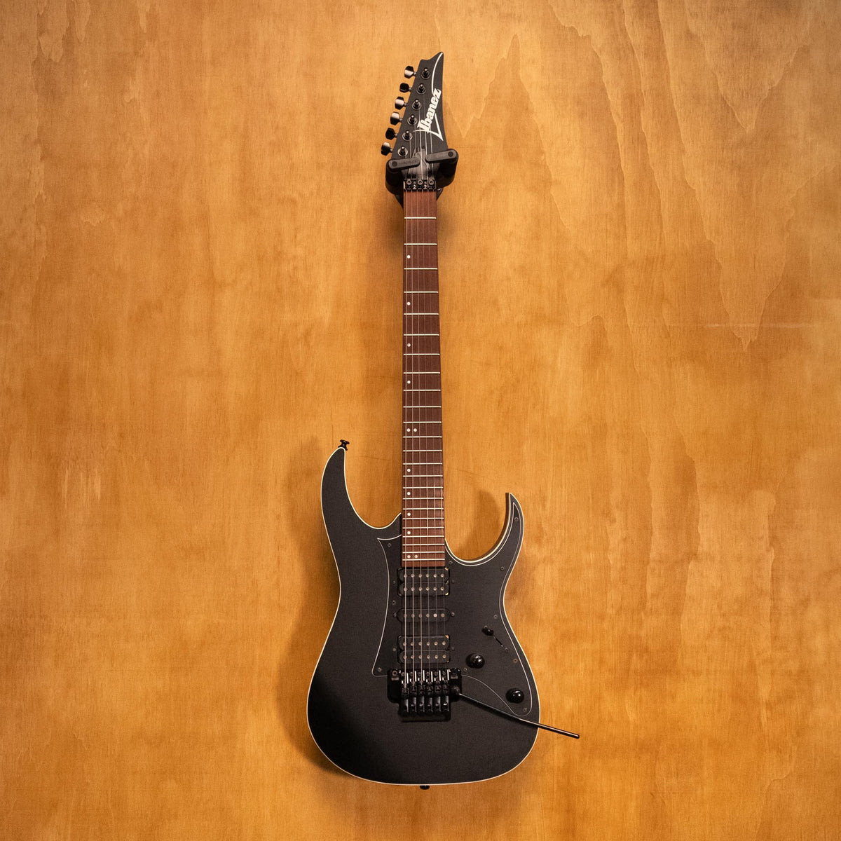 Ibanez RG450B-WK electric guitar in weathered black with sleek body and six strings, showcasing its modern design and hardware.