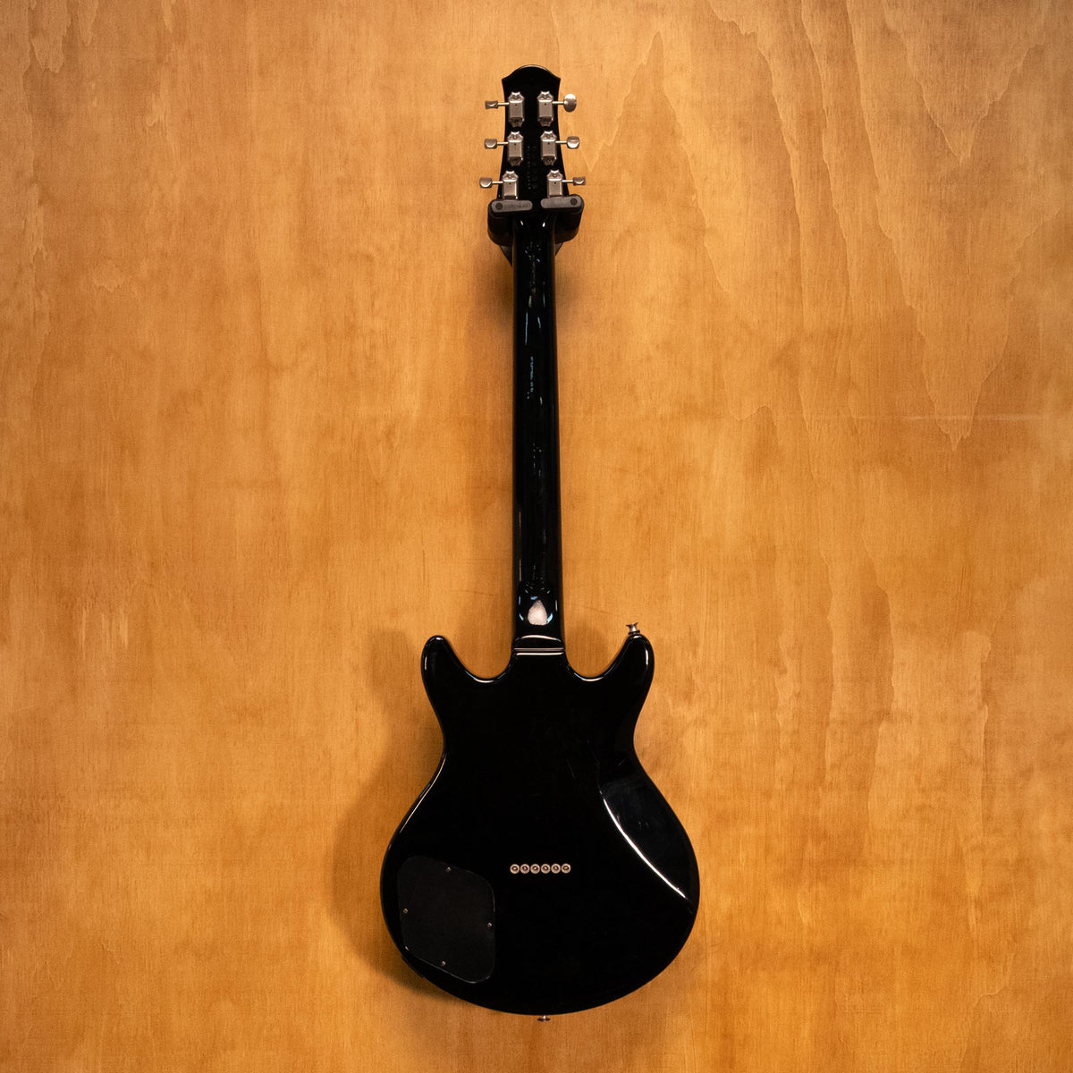 Yamaha SG-RR electric guitar in standard black with double-cutaway design, shown on a stand against a plain background.