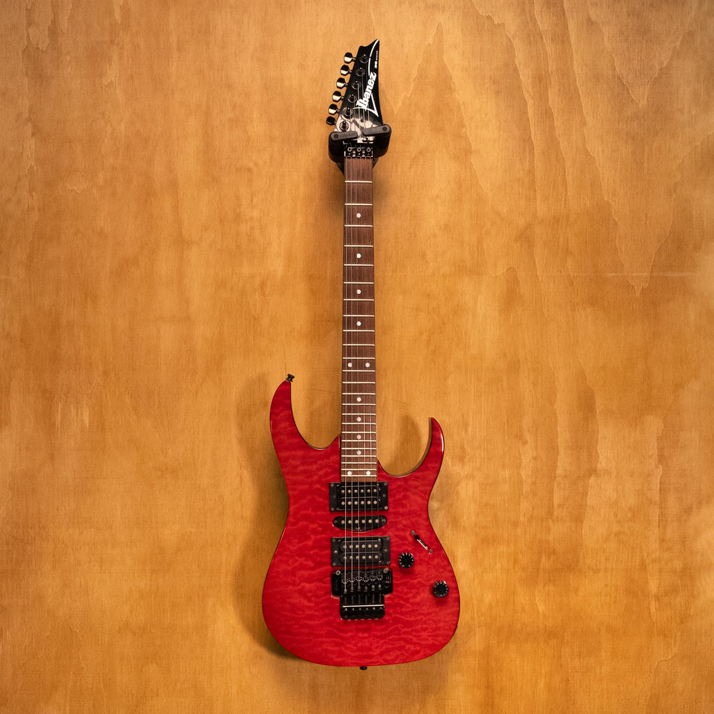 Ibanez RG380DX-QM electric guitar with a sleek body, multi-color quilted maple top, and modern hardware, preowned.