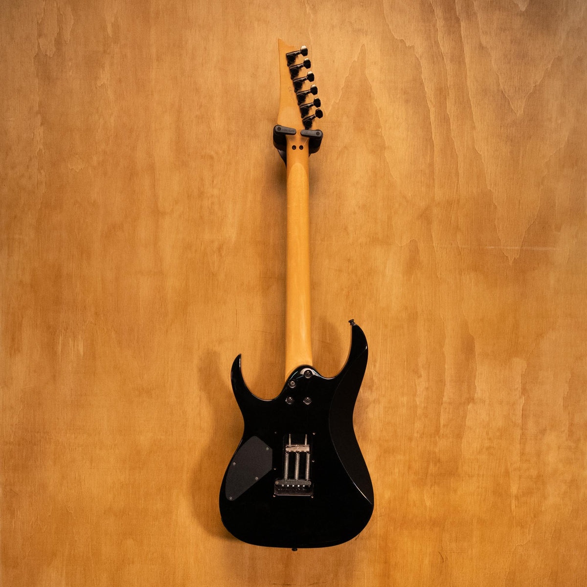 Ibanez RG380DX-QM electric guitar with a sleek body, intricate quilted maple top, and six-string design.