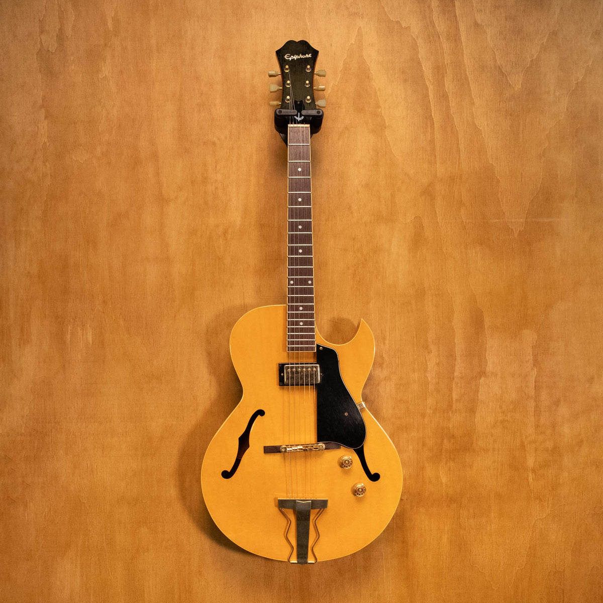 Epiphone Zephyr Regent electric guitar in natural finish, showcasing its vintage design and wood grain details.