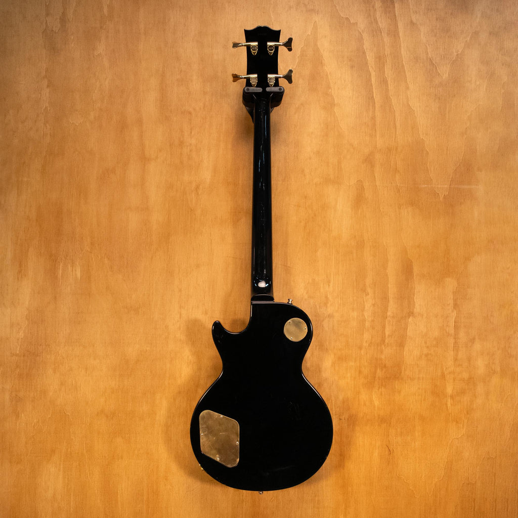 Preloved Greco EGB bass guitar with dark wood finish, four strings, and chrome tuning pegs, resting on a stand.