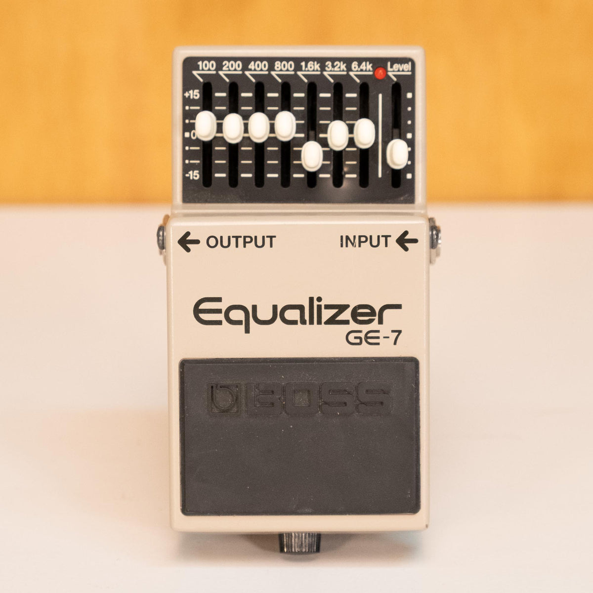 BOSS GE-7 Equalizer guitar effects pedal with seven adjustable bands, shown in close-up with control knobs visible.
