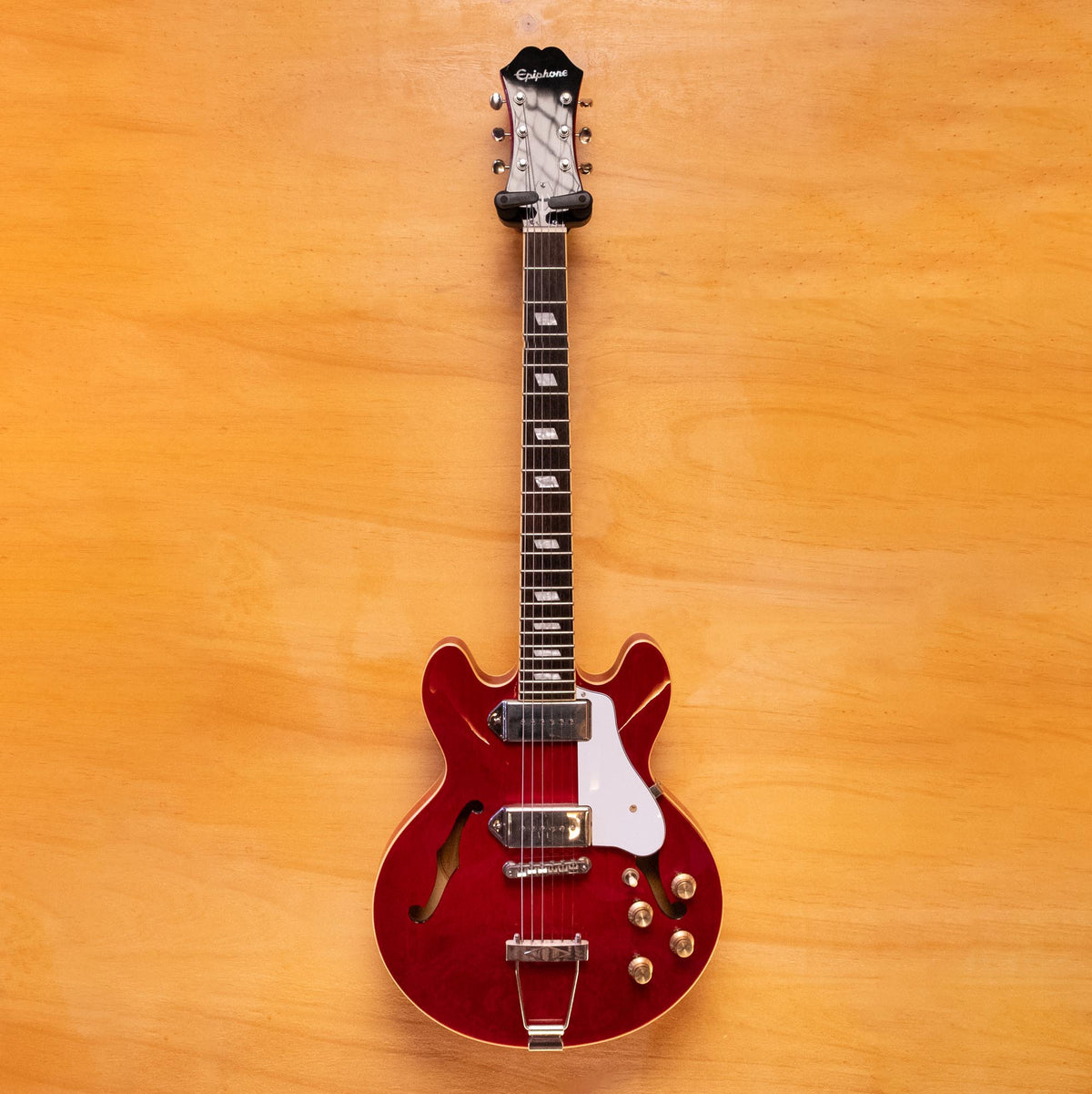 Epiphone Casino Coupe electric guitar in cherry finish, featuring a hollow body and chrome hardware.