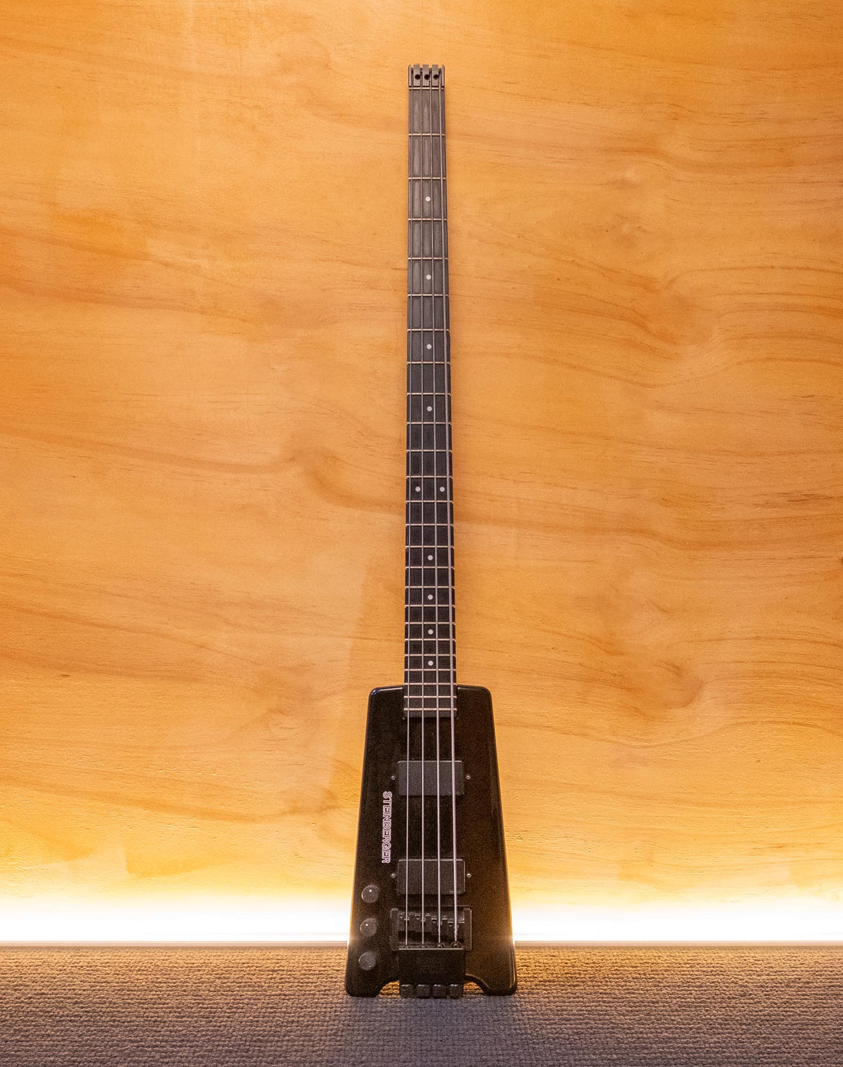 Left-handed Steinberger Original L2 bass guitar with sleek design and natural wood finish, shown in a close-up shot.