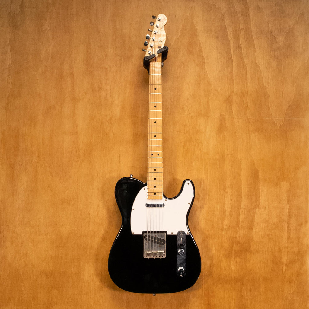 Fender '70s Telecaster TL71 electric guitar in black with maple neck, made in Japan, shown on a stand.