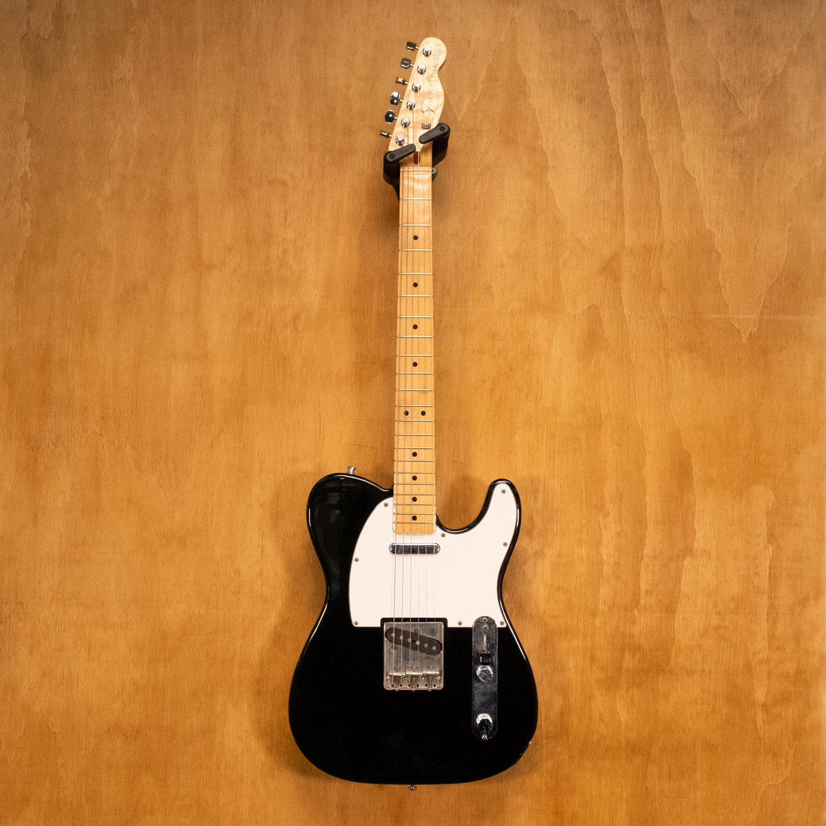 Fender '70s Telecaster TL71 electric guitar in black with maple neck, made in Japan, shown on a stand.
