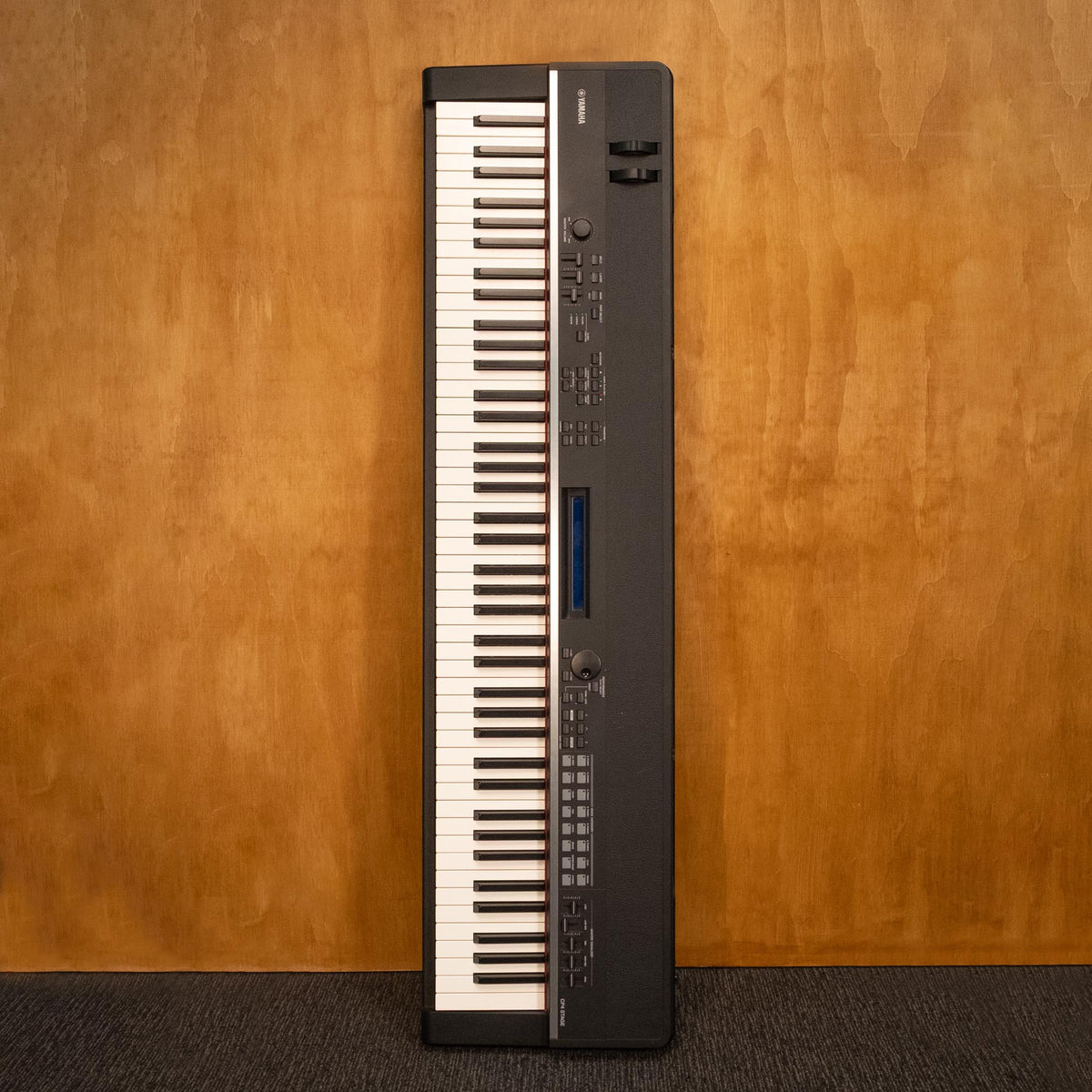 Yamaha CP4 Stage Piano, a sleek black stage keyboard with multiple control knobs and keys, designed for professional performance.