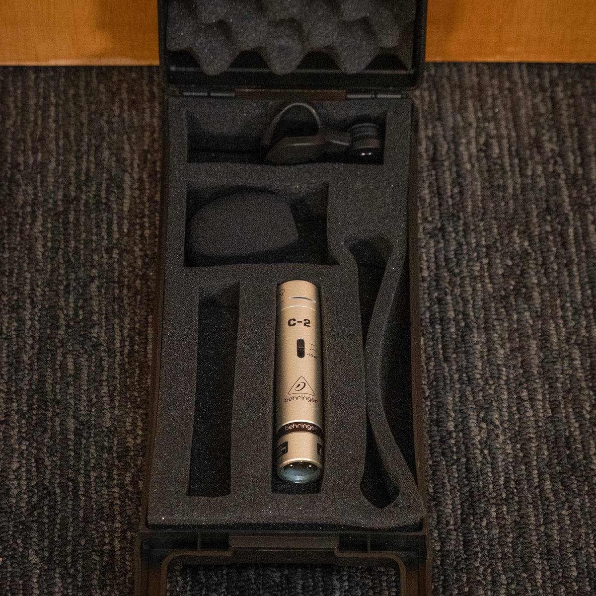 Behringer C-2 condenser microphone for live use, wired professional microphone with dual capsules, shown in a close-up image.