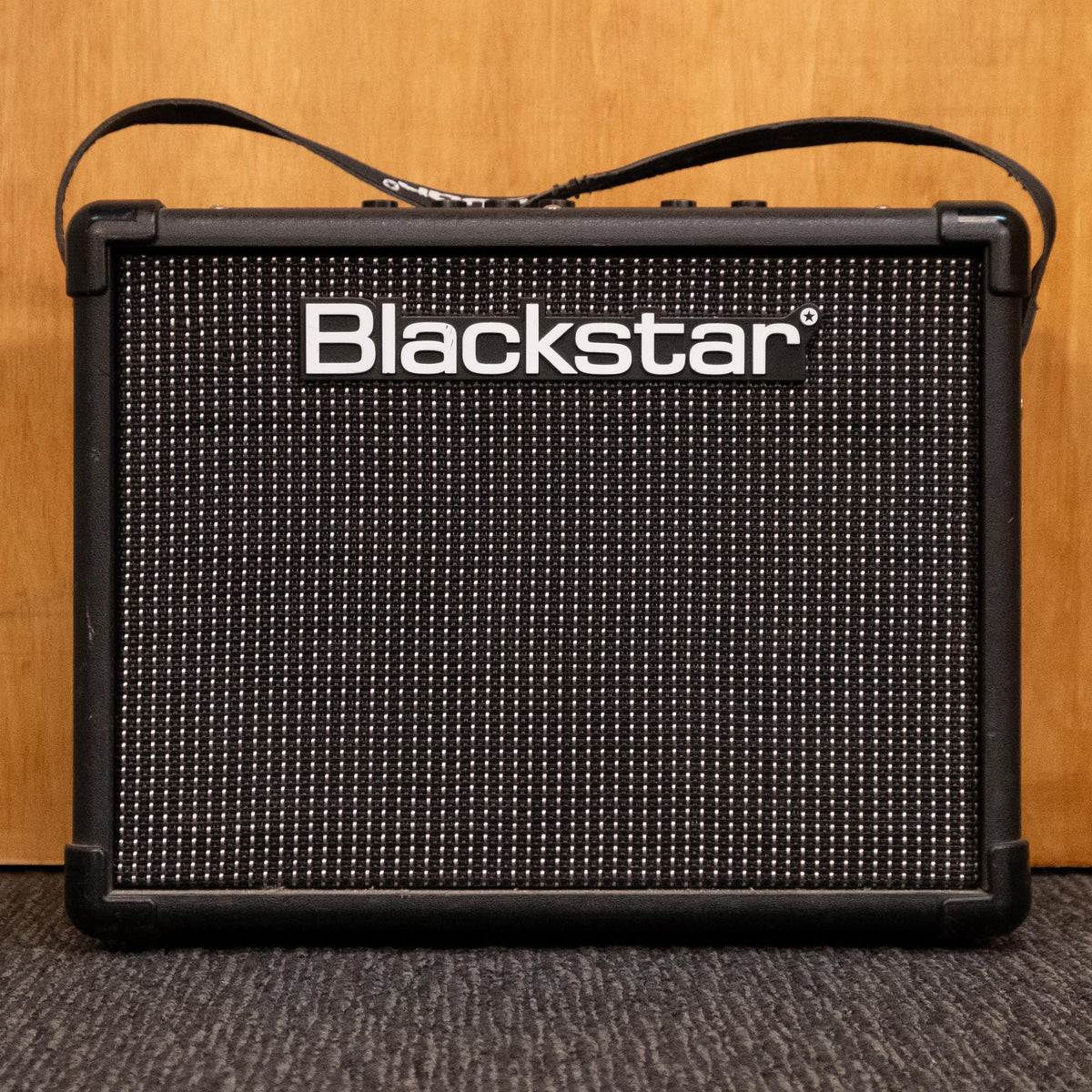 Blackstar ID Core 20 guitar amplifier combo in black, showing control panel and speaker grille for electric guitar use.