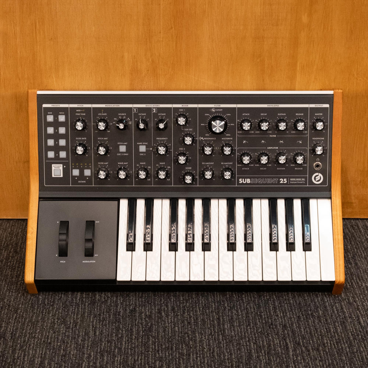 Moog Subsequent 25 analog synthesizer keyboard, made in USA, with control knobs and vintage design visible in the image.