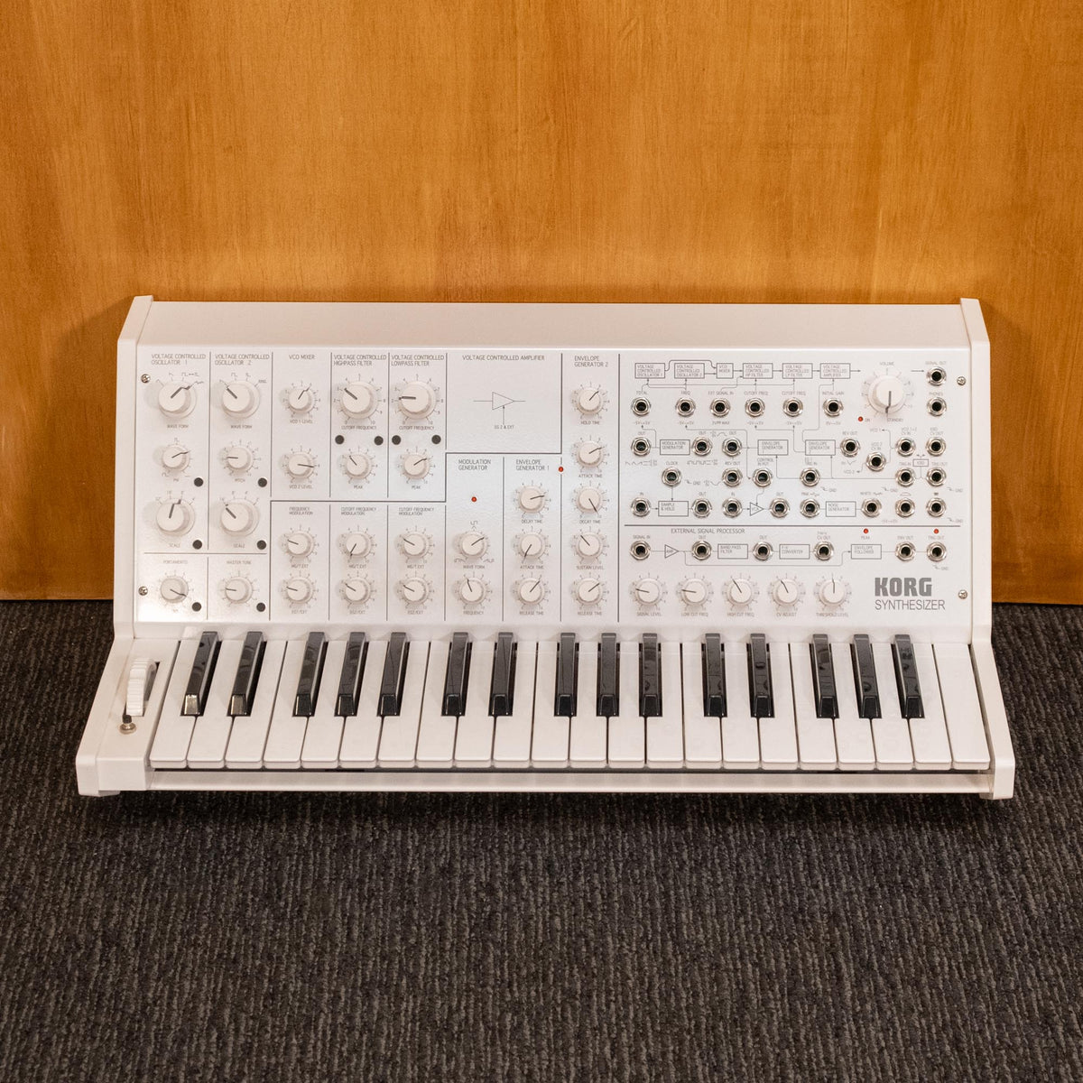 Korg MS-20 FS monophonic synthesizer keyboard with patch cables and control knobs, black and silver design, close-up view.