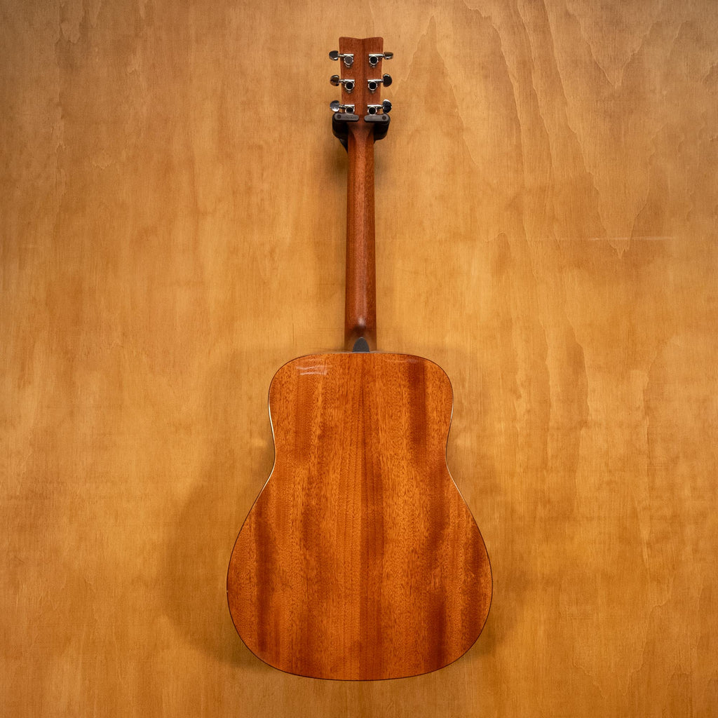 Yamaha FG800 acoustic guitar with a natural wood finish, shown resting on a stand against a plain background.