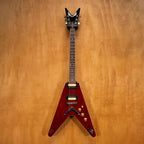 Dean 79 V electric guitar in transparent cherry finish, with double-cutaway body and chrome hardware, shown in a close-up shot.