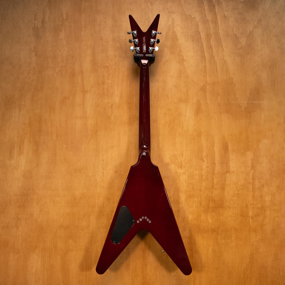 Dean 79 V electric guitar in transparent cherry finish, showcasing its classic shape and vibrant color.