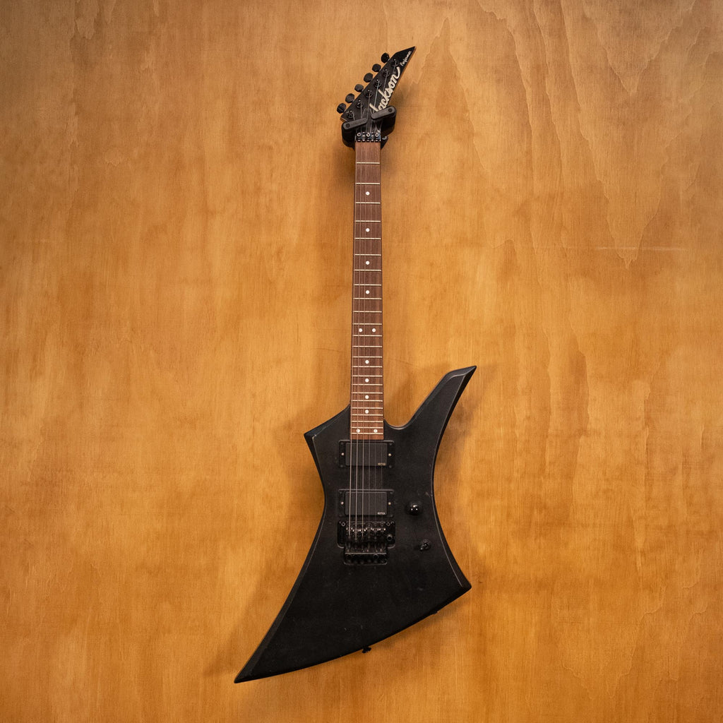 Jackson Kelly electric guitar with EMG pickups, black finish, shown with double-cutaway body and chrome hardware.