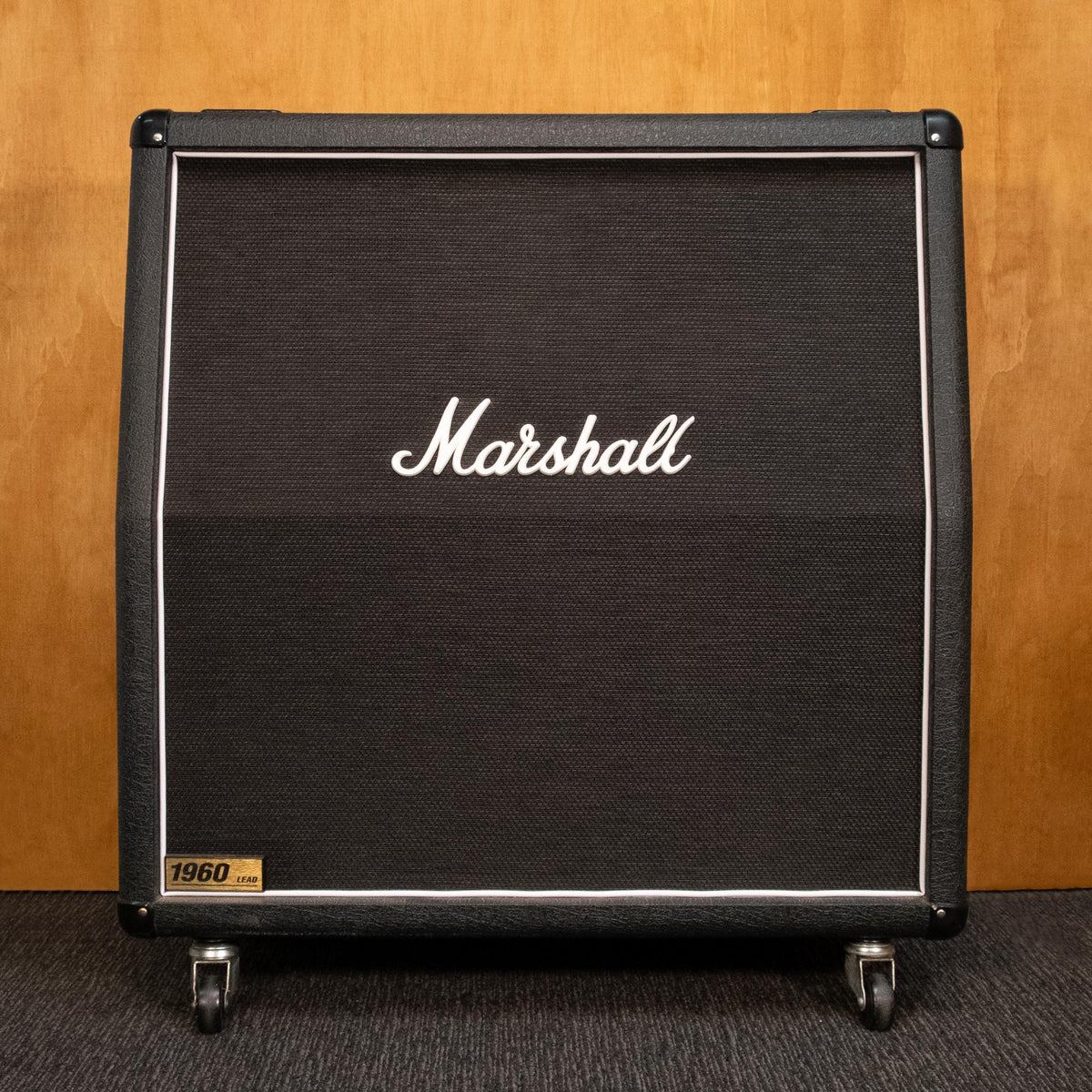 Marshall 1960A 4x12 guitar amplifier cabinet with vintage speaker grille and control panel, used condition, black finish.