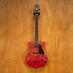 Ibanez AMH90 hollow body electric guitar in cherry red flat finish, showcasing the guitar's body and hardware details.