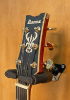 Ibanez AMH90 hollow body electric guitar in cherry red flat finish, featuring a sleek design and dual humbucking pickups.