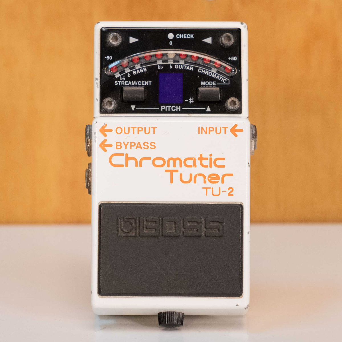 BOSS TU-2 chromatic tuner pedal for guitar and bass, black effects pedal with control knobs and input/output jacks.