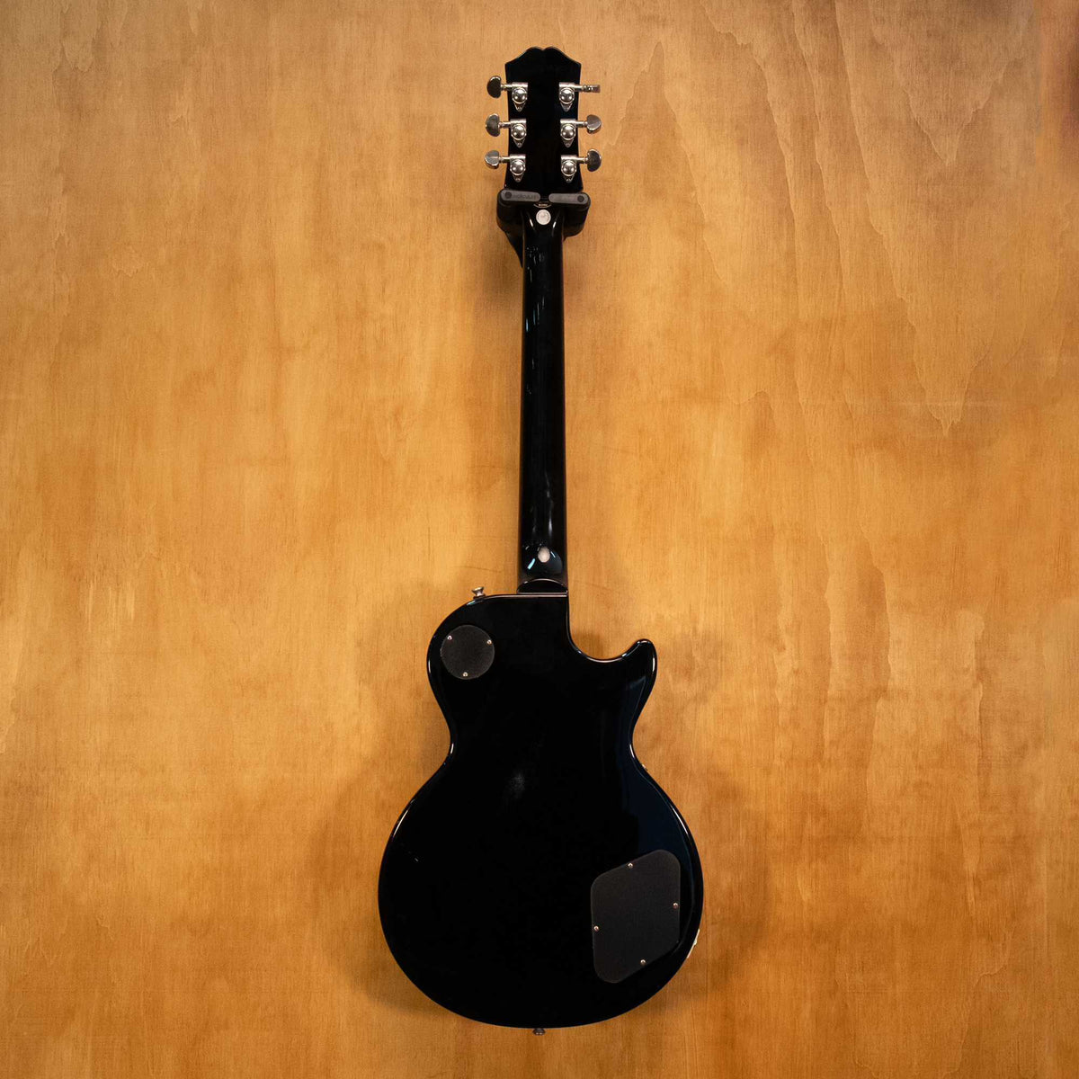 Left-handed Epiphone Les Paul electric guitar in ebony finish, showing the body, neck, and hardware details.