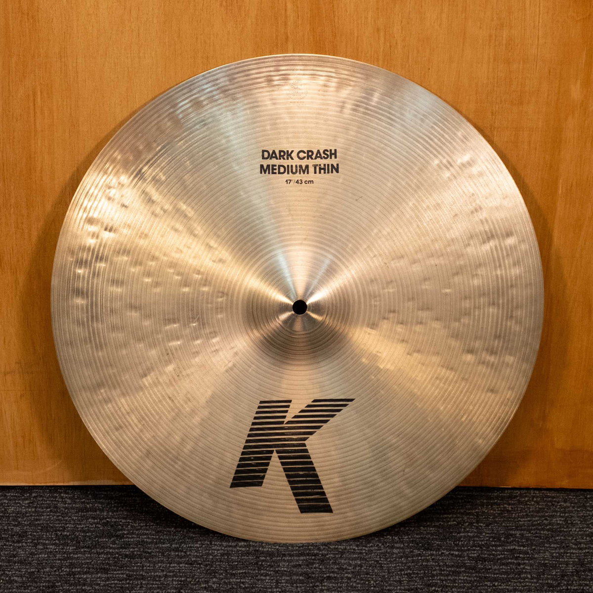Zildjian 17-inch K Dark Crash Medium Thin cymbal from the '90s, showing a detailed view of the preowned cymbal with patina and logo.