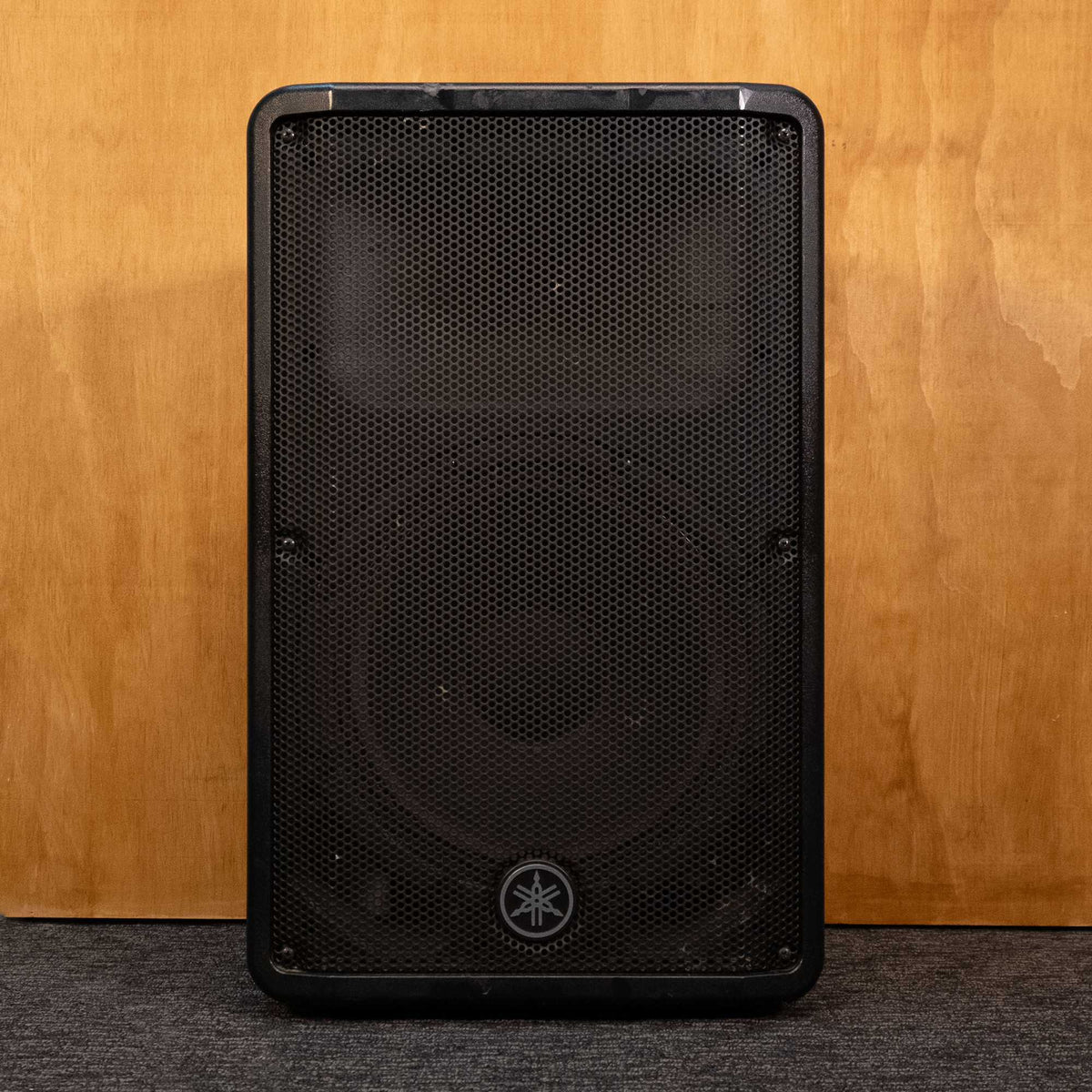 Yamaha DBR12 powered speaker with a black enclosure and front grille, designed for professional audio applications.