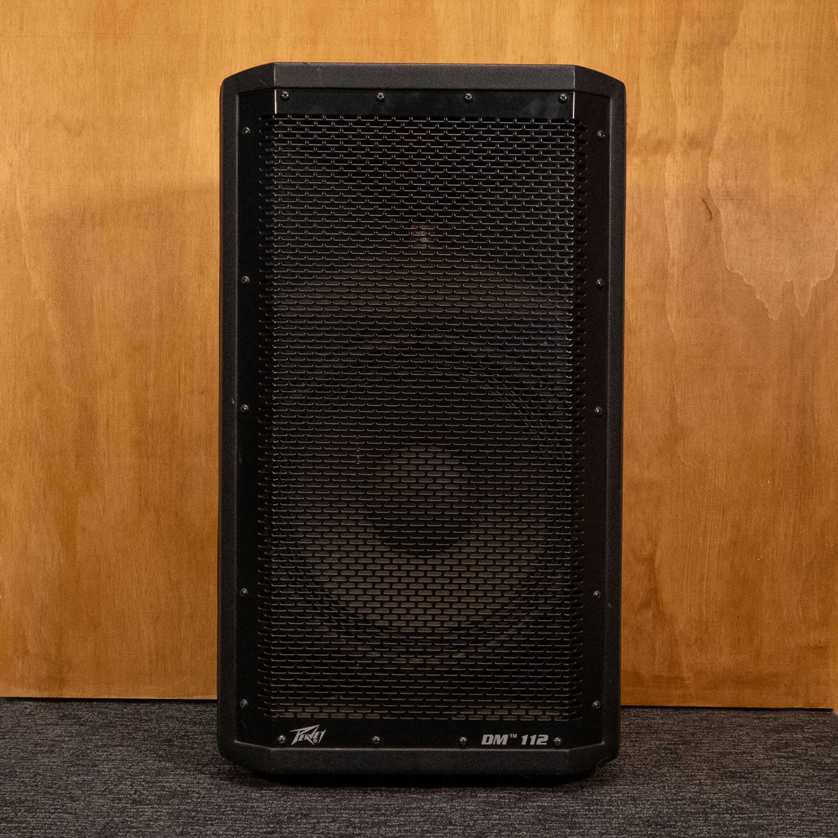 Peavey DM112 powered speaker, black professional audio speaker with control panel and speaker grille, used condition.