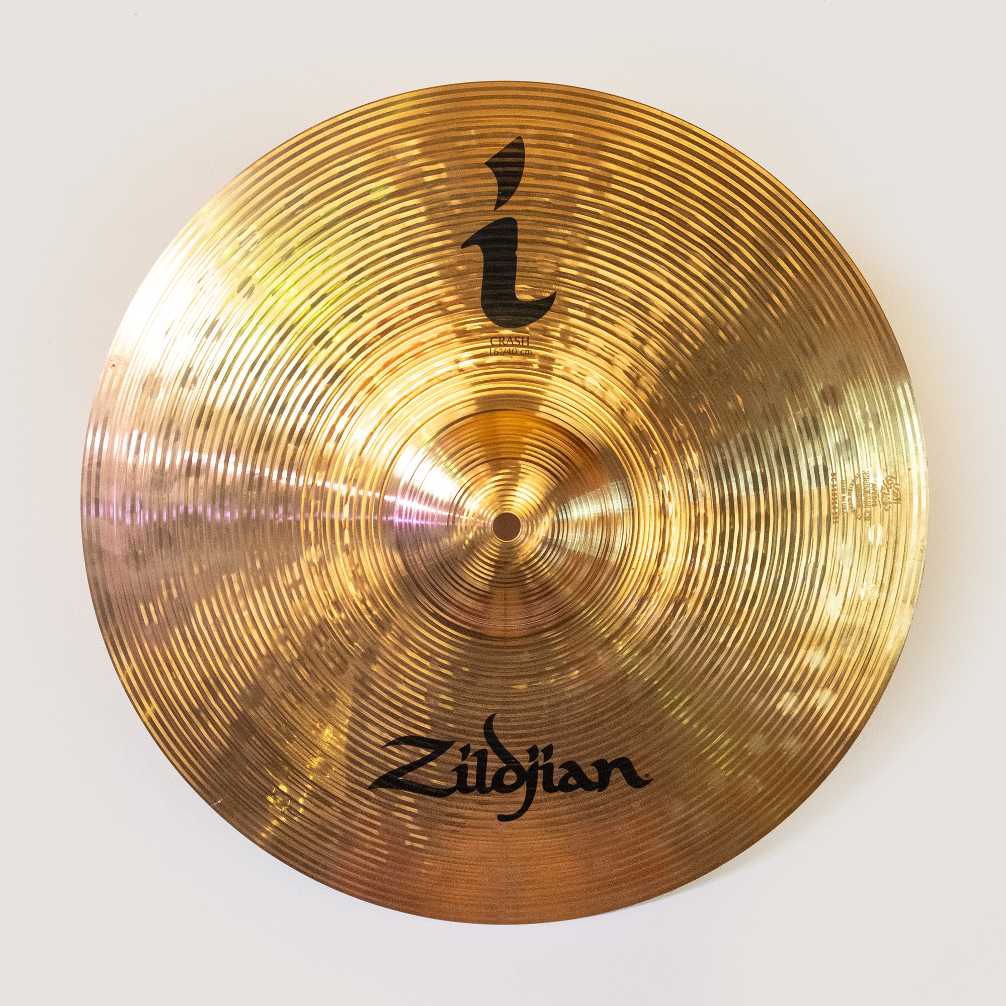 Zildjian I 16 inch crash cymbal, preloved, showcasing its shiny surface and unique design in the image.