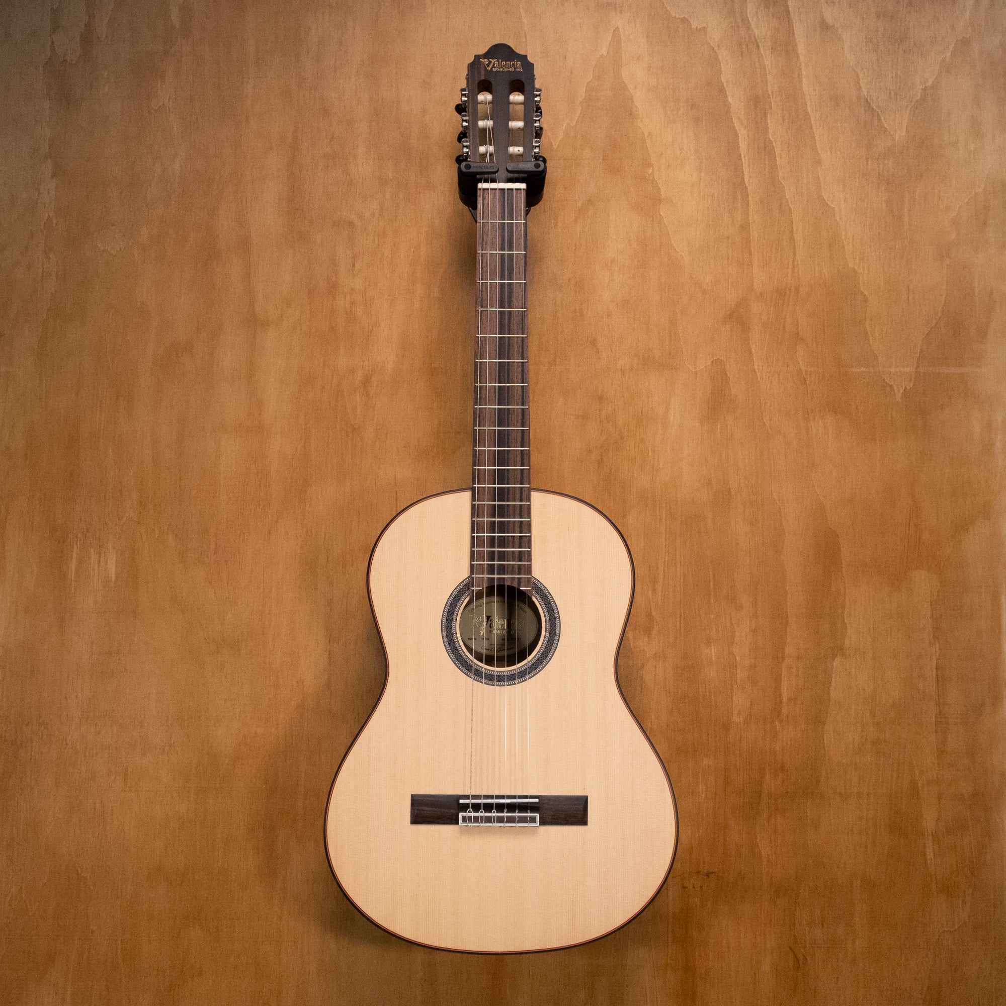 Preloved Valencia VC704 classical guitar in natural wood finish, showing the body and strings on a white background.