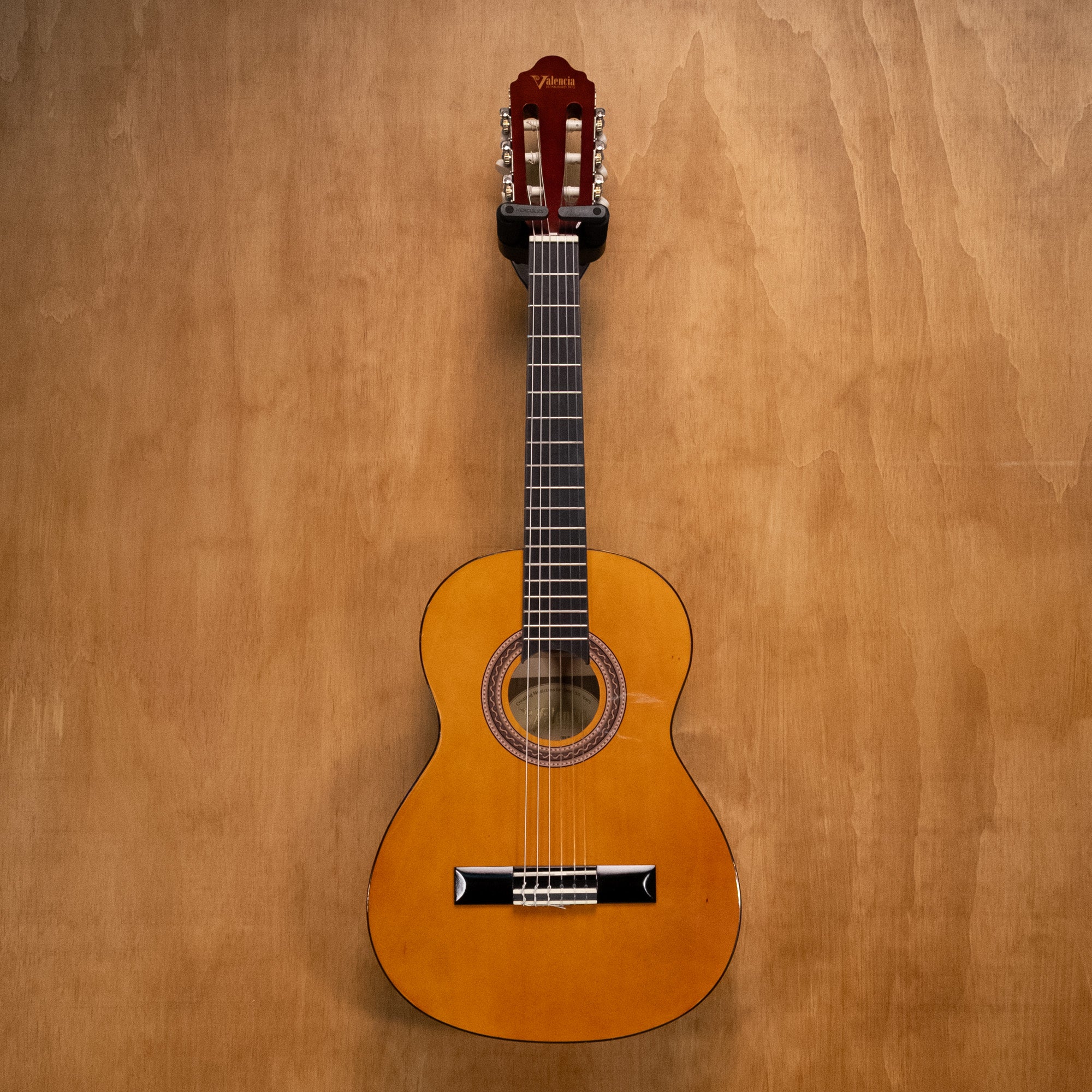 Preloved Valencia VC102 1/2 classical guitar kit in natural finish, showing the compact guitar with strings and wood grain details.