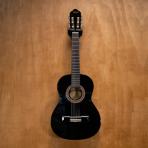 Preloved Valencia VC102 1/2 classical guitar in black, showing the body, neck, and strings on a plain background.
